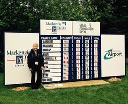 Leeanne Portelance (Thunder Bay mill) checks out the leaderboard for the tournament on Thursday morning. 